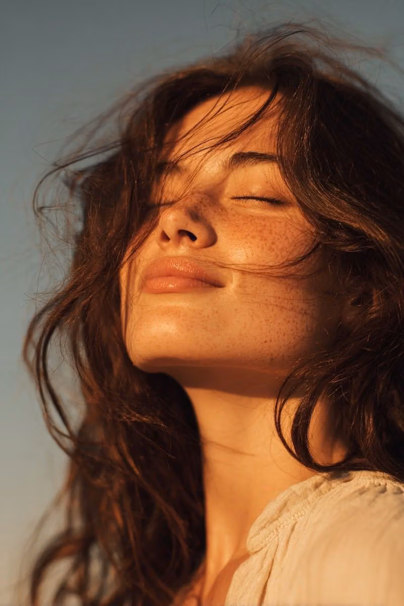 Ultra-realistic golden hour close-up portrait of a young wom
