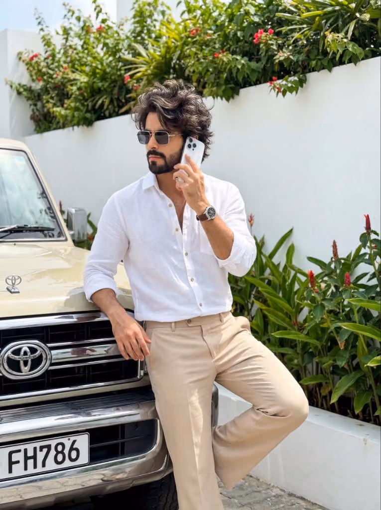 Stylish Boy with iPhone Leaning on Land Cruiser