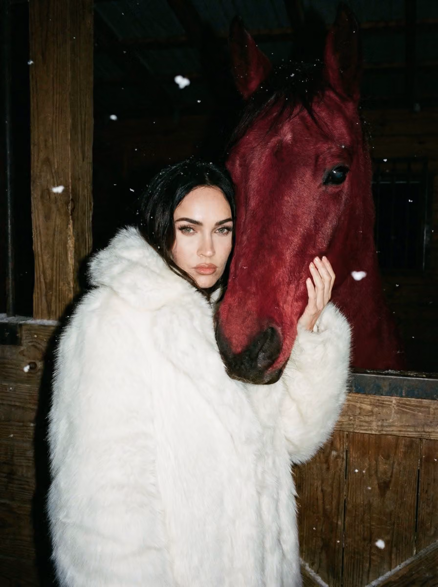 Woman in White Fur with Crimson Horse in Stable