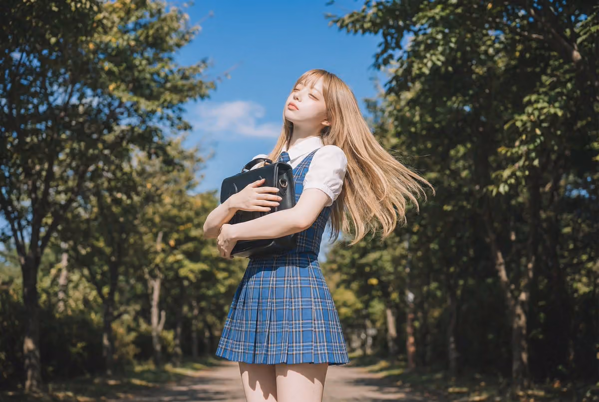 Blonde Girl in School Uniform on Tree-Lined Street