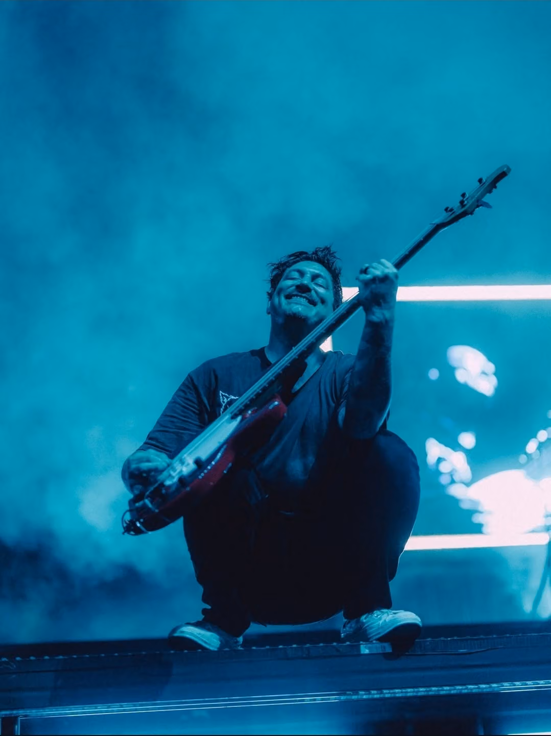 Musician on Stage with Neon Lights and Fog
