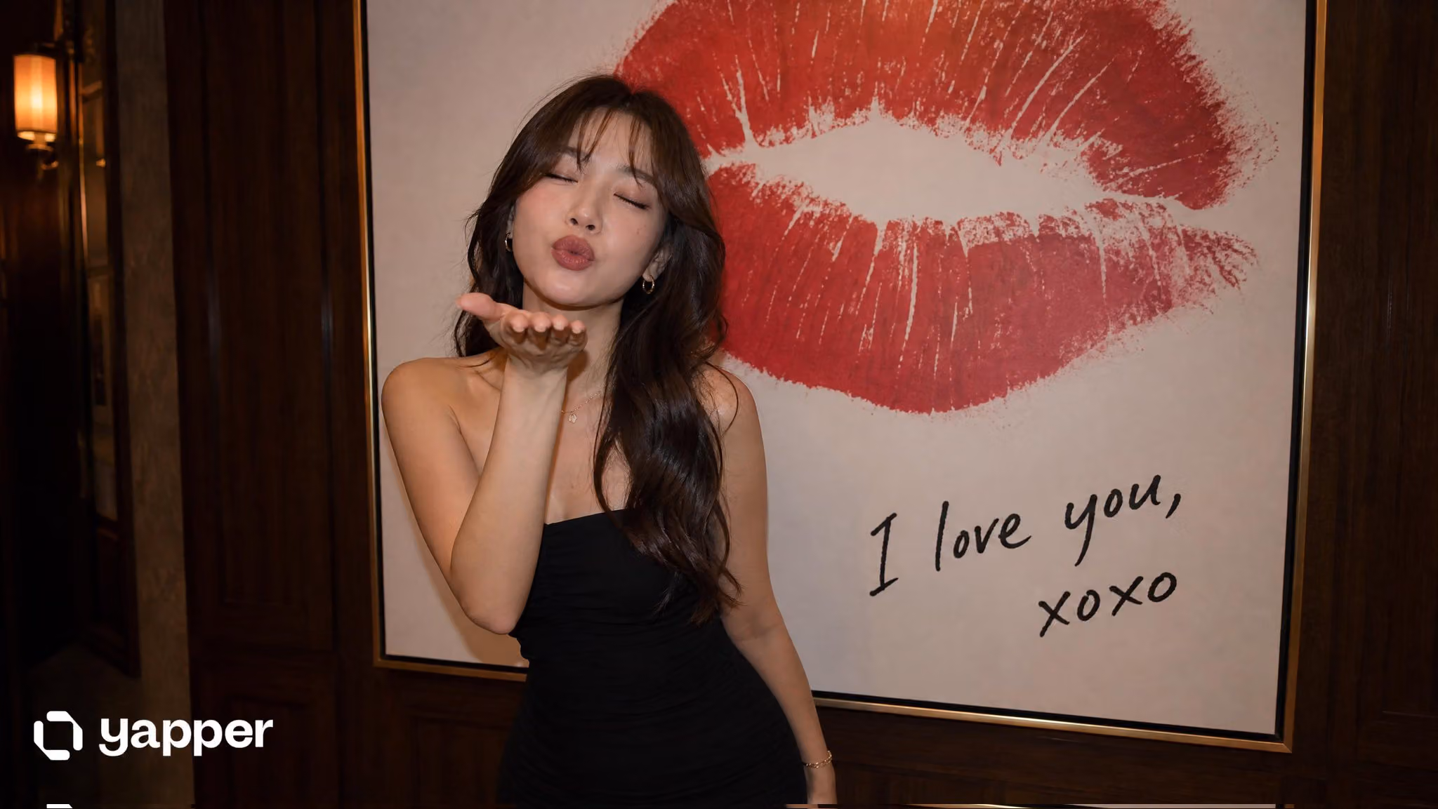 East Asian Woman Blowing Kiss in Elegant Dress